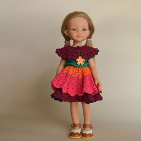 Front view of multicolor crochet doll dress with flower applique