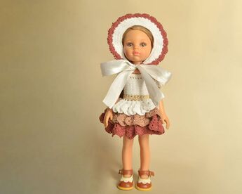 Full-length front view of the doll wearing the full set: ruffle dress and bonnet with a satin bow.