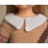 White crochet collar on doll dress, close-up of stitching and texture